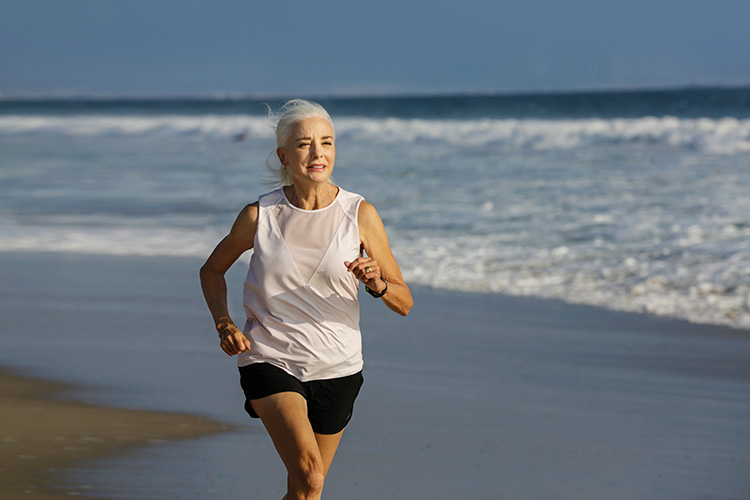 Bobbie Poledouris running on the beach.