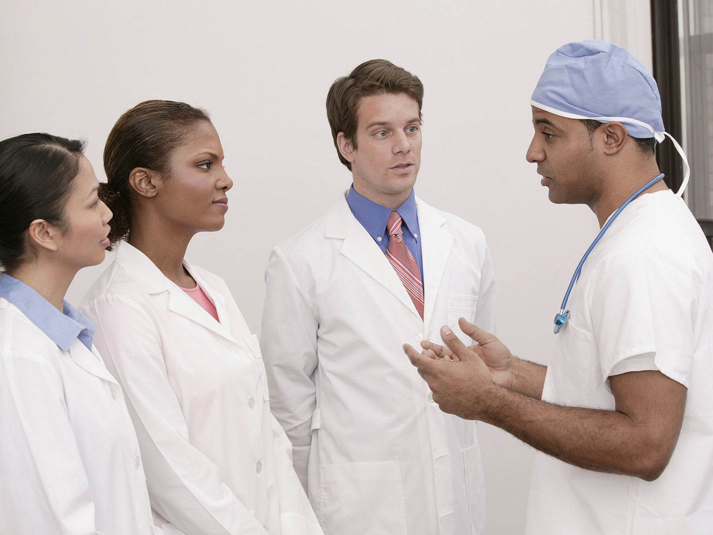 Surgeon talking to medical interns.