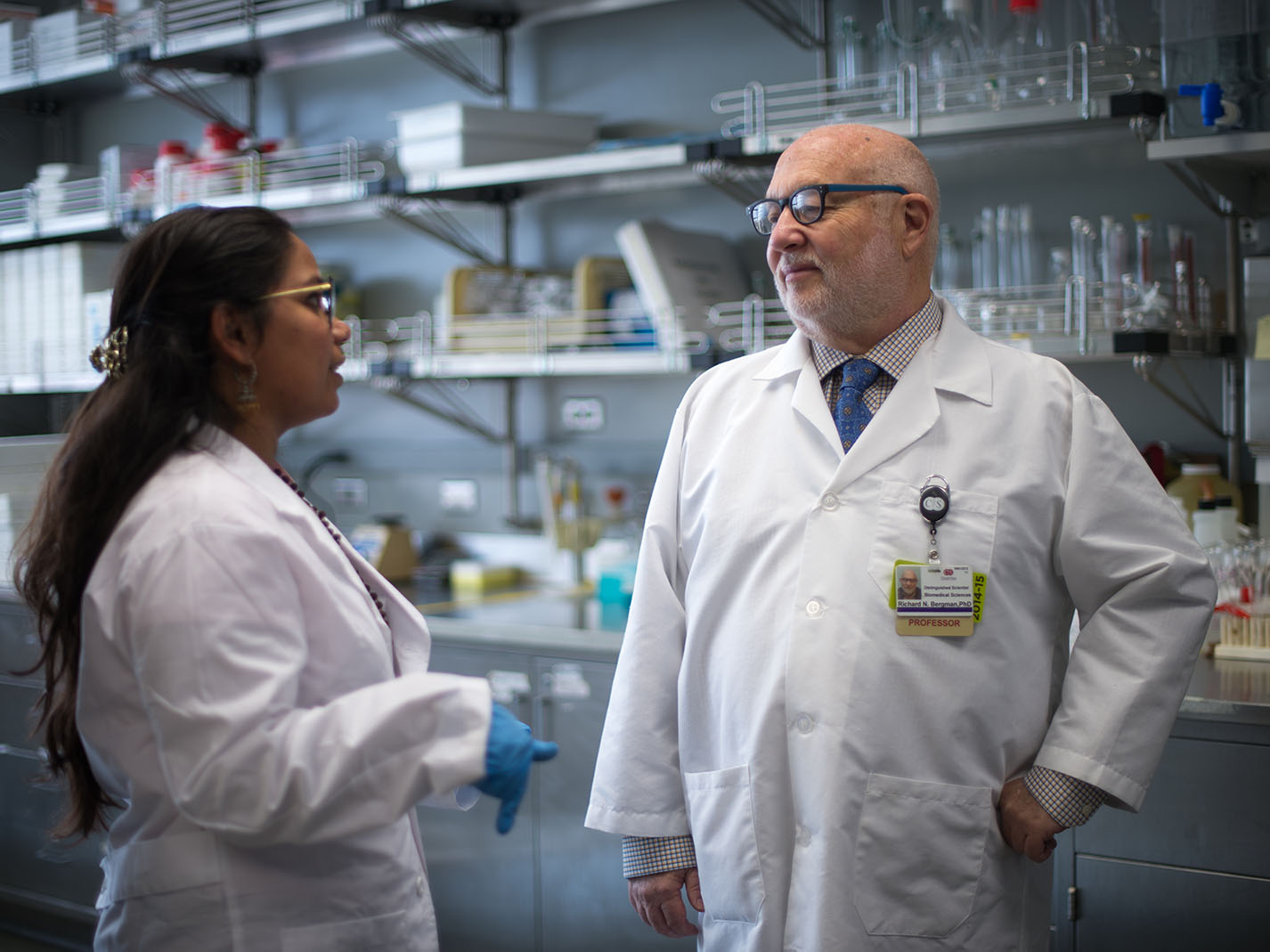 Dr. Bergman speaking with researcher in his lab