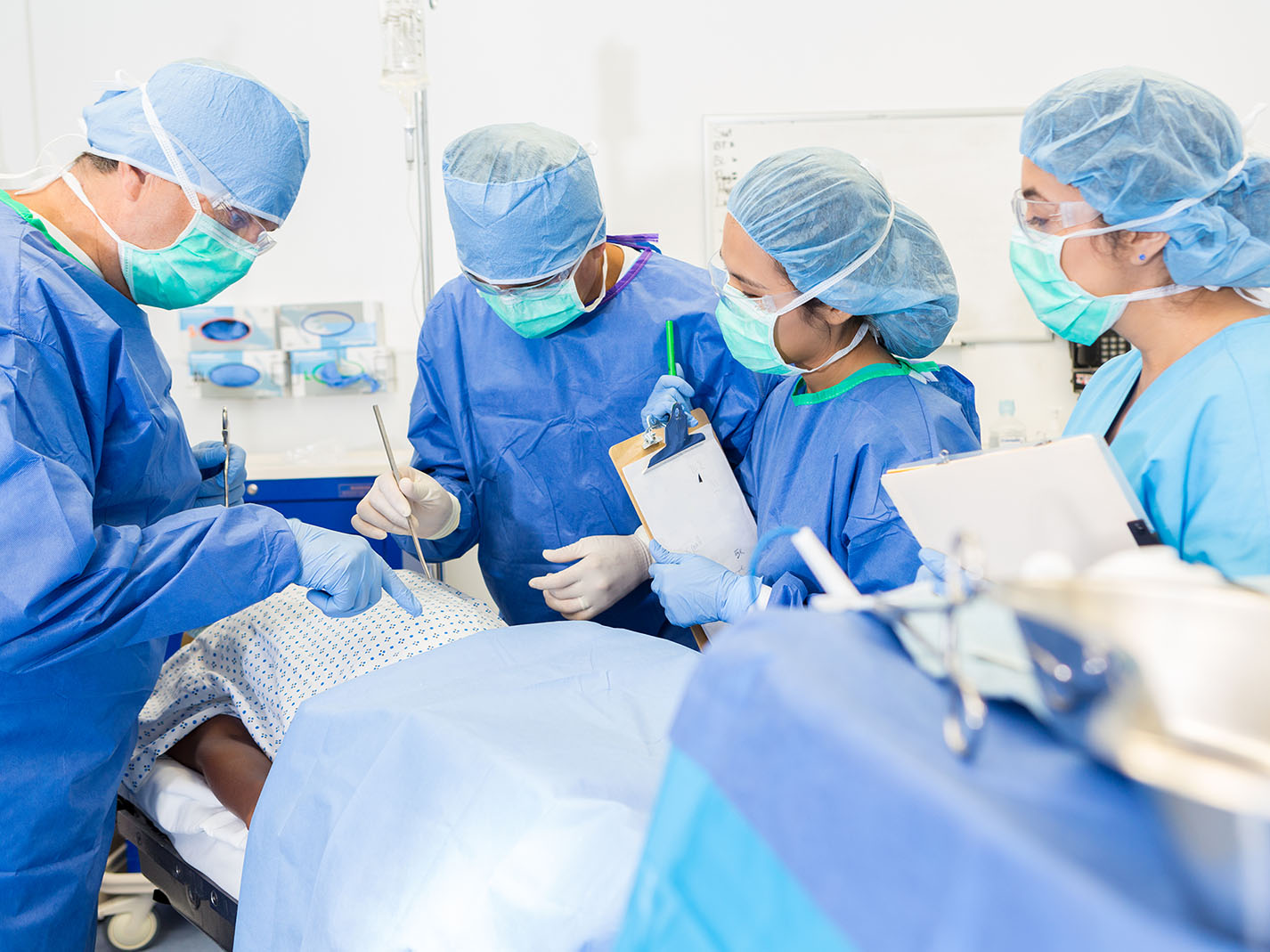 Medical students in operating room with faculty surgeon